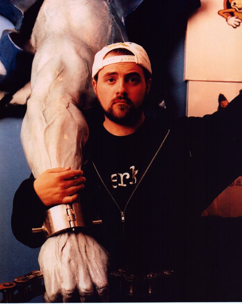 Kein Smith Holding Giant Arm Photo Print showcasing a playful scene.