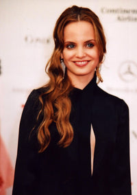 Mena Suvari photo print in black open front dress, elegant portrait.