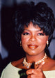 Oprah Winfrey pointing in a green top and gold choker photo print