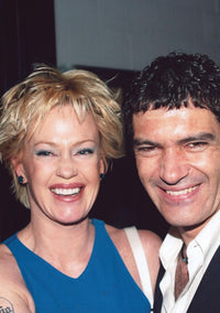 Melanie Griffith in blue tank top with Antonio Banderas photo print.