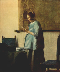 The Reader fine art print by Johannes Vermeer showcasing a woman reading.
