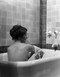 1920s-1930s young brunette woman relaxing in luxury bathtub poster print.