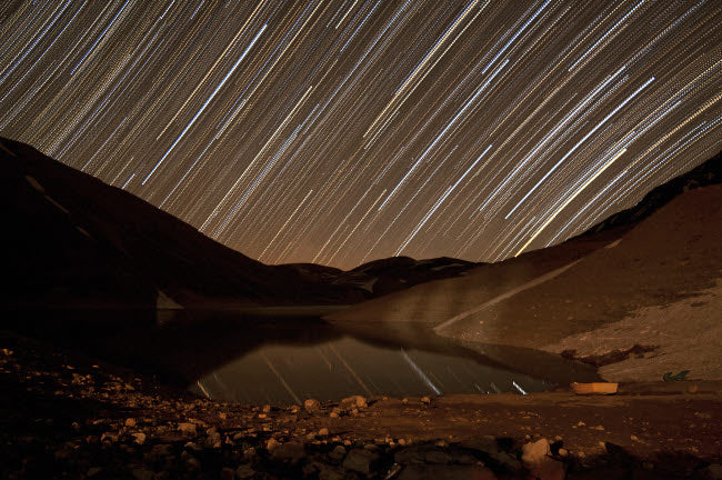 Star trails over Taar Lake art print by Amin Jamshidi featuring a night sky.