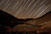 Star trails over Taar Lake art print by Amin Jamshidi featuring a night sky.