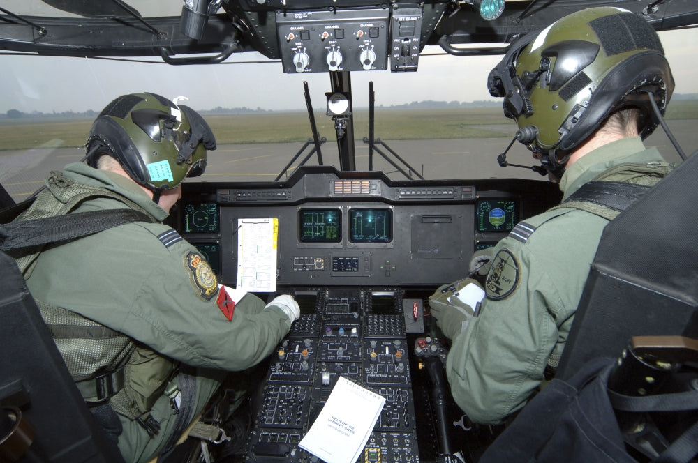 Pilots inside the cockpit of a Royal Air Force Merlin Helicopter poster print.