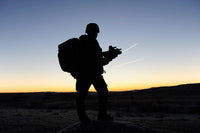 A British soldier on patrol at sunrise poster print by Andrew Chittock.