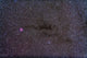 The Cocoon Nebula (IC 5146) poster print showcasing vibrant red and blue colors.
