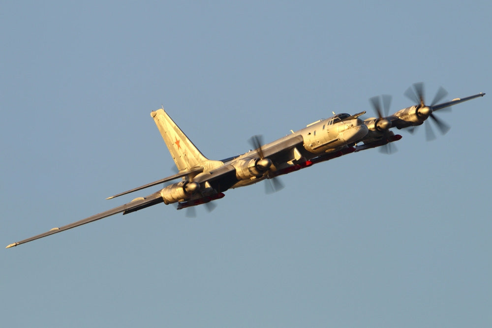 Tu-95MSM strategic bomber with X-101 missiles performing test flight poster print.