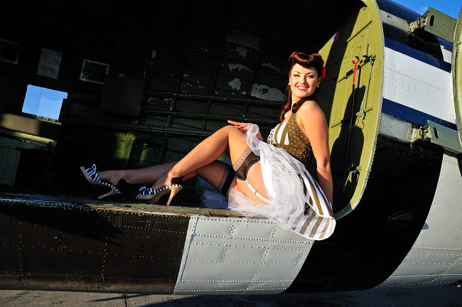 1940s style pin-up girl sitting inside C-47 Skytrain aircraft poster print