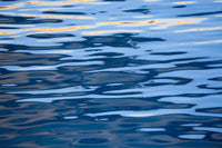 Sunset Reflection Abstract Art Print by David Fleetham showcasing vibrant colors on calm ocean waters.
