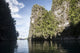 Rugged limestone islands framing an Indonesian pinisi schooner poster print.