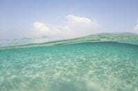 Sunlight rippling across a shallow sand flat in Indonesia poster print.