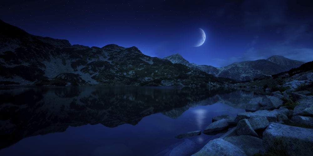 Moonrise over tranquil lake and mountains in Pirin National Park, Bulgaria poster print.