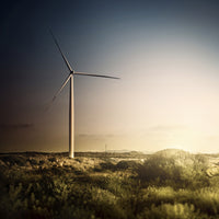 Wind turbine in a tranquil field during evening in Sardinia, Italy.