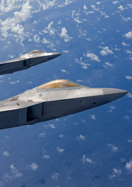 Two F-22 Raptors flying in formation over Japan poster print.