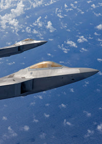 Two F-22 Raptors flying in formation over Japan poster print.