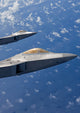 Two F-22 Raptors flying in formation over Japan poster print.