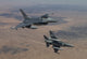 Two F-16 fighter jets from the 56th Fighter Wing flying over the Arizona desert.