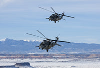 Two HH-60G Pave Hawk helicopters flying in formation during training.