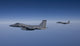Two F-15 Eagles flying over the Gulf of Mexico poster print