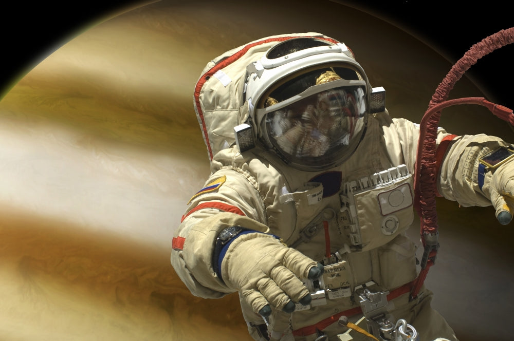 Cosmonaut floating in space above a large alien planet poster print