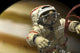 Cosmonaut floating in space above a large alien planet poster print