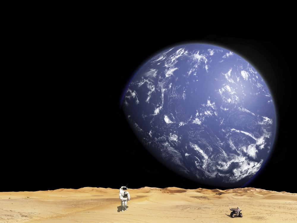 Astronaut exploring a barren moon with rover poster print