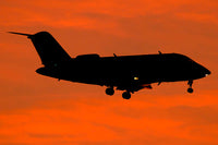 Bombardier Challenger CL-600 private jet flying over Italy scenic view.