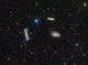 The Leo Triplet Poster Print showcasing three galaxies in vibrant colors.