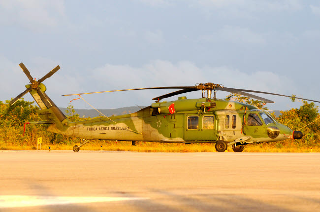 Brazilian Air Force UH-60 helicopter at sunset poster print by Riccardo Niccoli