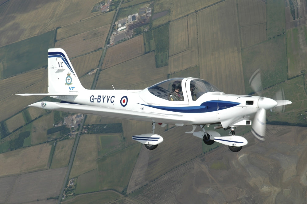 G-115 Tutor of the Cambridge University Air Squadron poster print featuring an in-flight view over England.