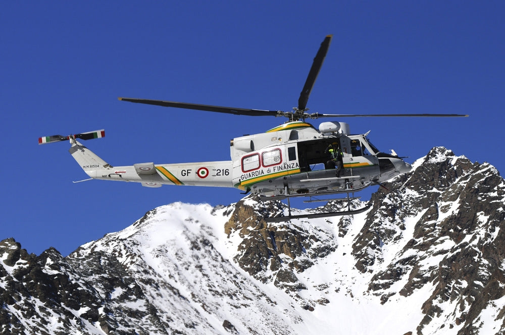 AB.412 helicopter flying over the Alps poster print by Riccardo Niccoli