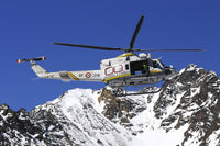 AB.412 helicopter flying over the Alps poster print by Riccardo Niccoli