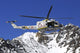 AB.412 helicopter flying over the Alps poster print by Riccardo Niccoli