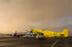 Three P-51 Mustangs parked on the ramp ahead of a storm poster print.