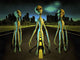 Surreal poster print featuring aliens on a road with a city and flying saucers.