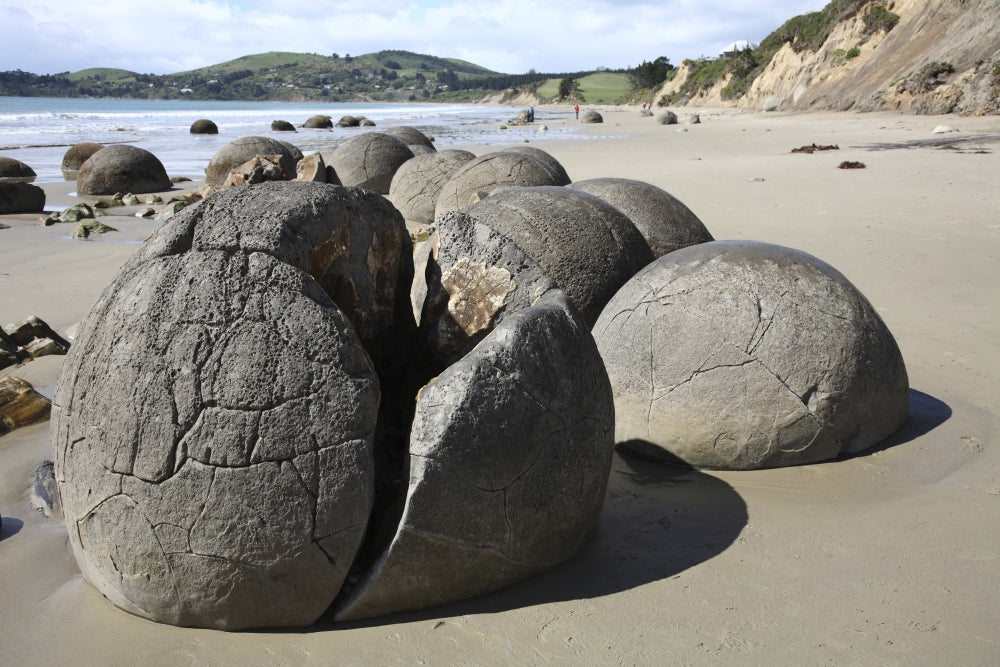 Moeraki Boulders Poster Print showcasing unique spherical septarian concretions on Koekohe Beach, New Zealand.