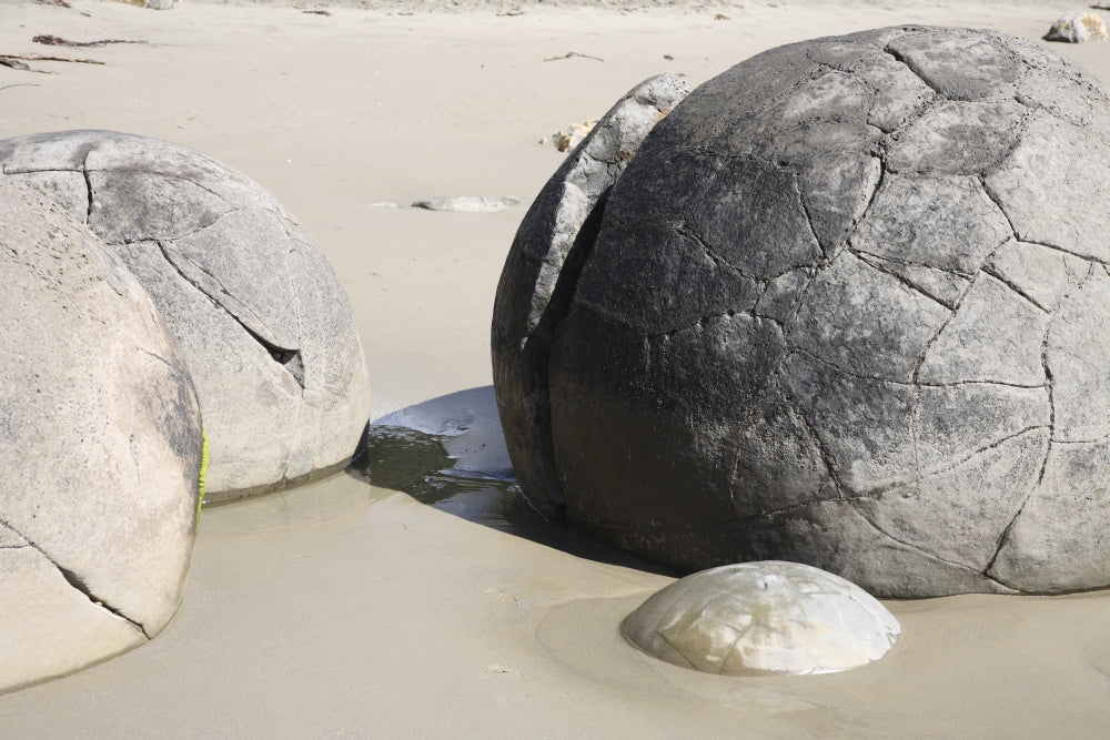 Moeraki Boulders poster print showcasing spherical septarian concretions on Koekohe Beach, New Zealand.