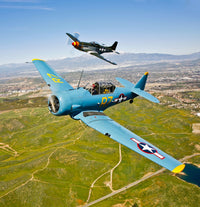 A North American T-6 Texan and P-51D Mustang flying over Chino, California poster print.