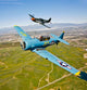 A North American T-6 Texan and P-51D Mustang flying over Chino, California poster print.