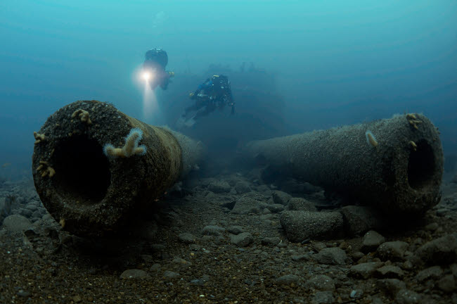 Two divers exploring the HMS Audacious shipwreck poster print by Steve Jones