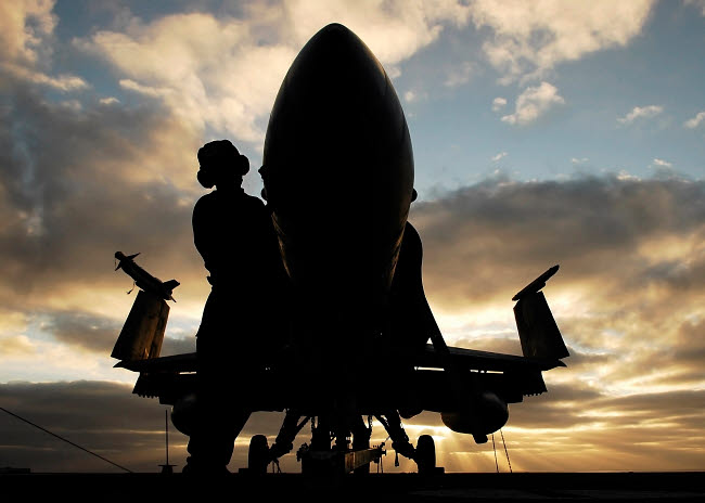 A Sailor cleaning the nose of an F/A-18F Super Hornet poster print.