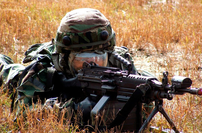 An Airman Takes Up a Firing Position Poster Print showcasing military dedication.