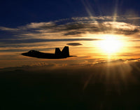 F/A-22 Raptor Training Mission Poster Print featuring a fighter jet at sunset.