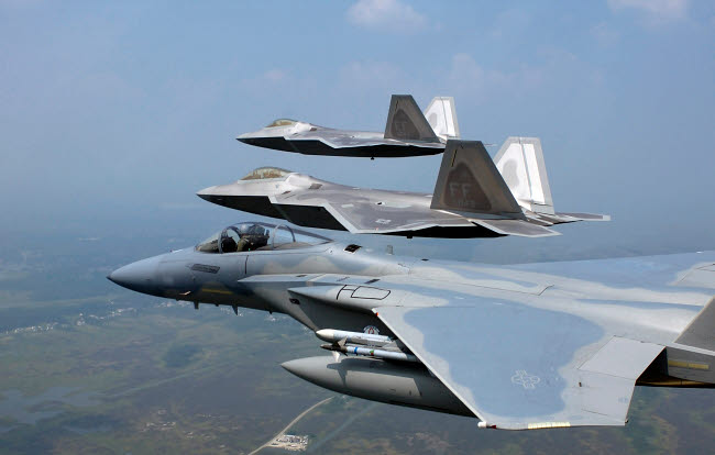 Three F/A-22 Raptors flying in formation poster print.