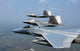 Three F/A-22 Raptors flying in formation poster print.