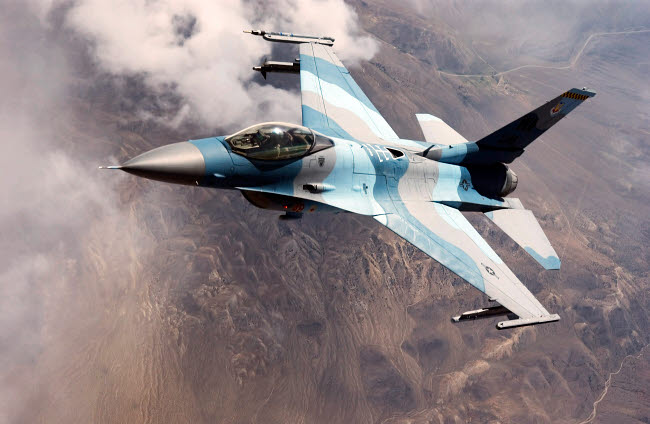 F-16 Falcon in flight poster print showcasing a fighter jet soaring through the sky.