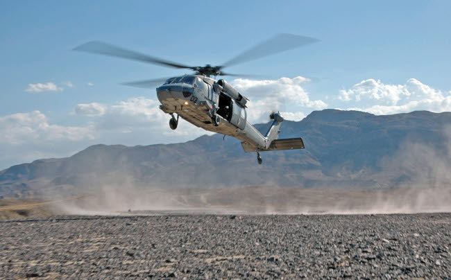 MH-60S Seahawk helicopter practicing landings in the desert poster print.