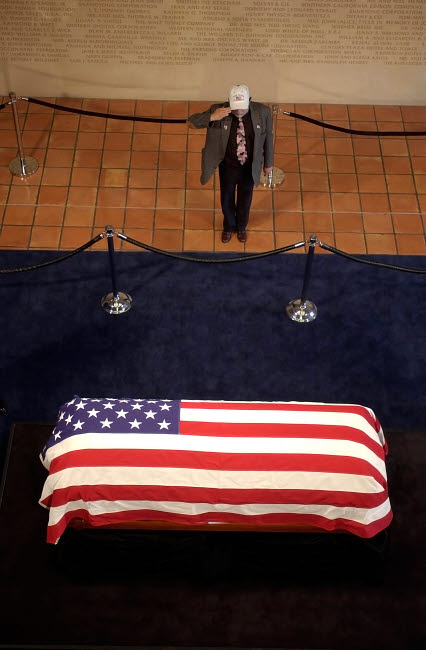 A mourner pays respects to Ronald Reagan poster print.