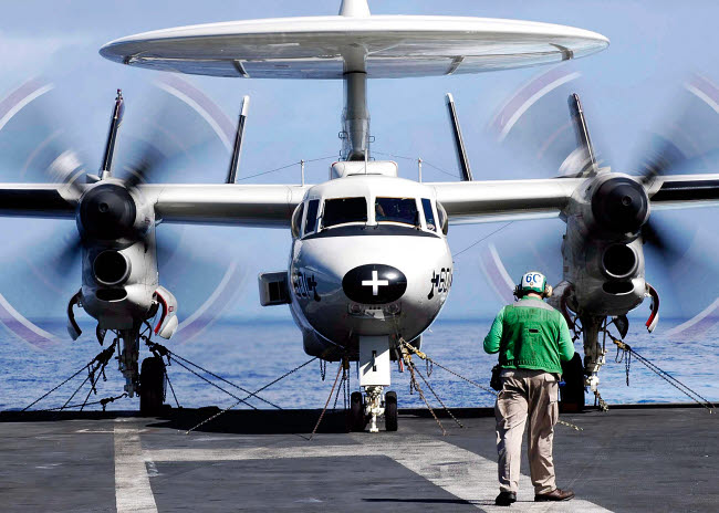 E-2C Hawkeye flying over USS Abraham Lincoln aircraft carrier poster print.